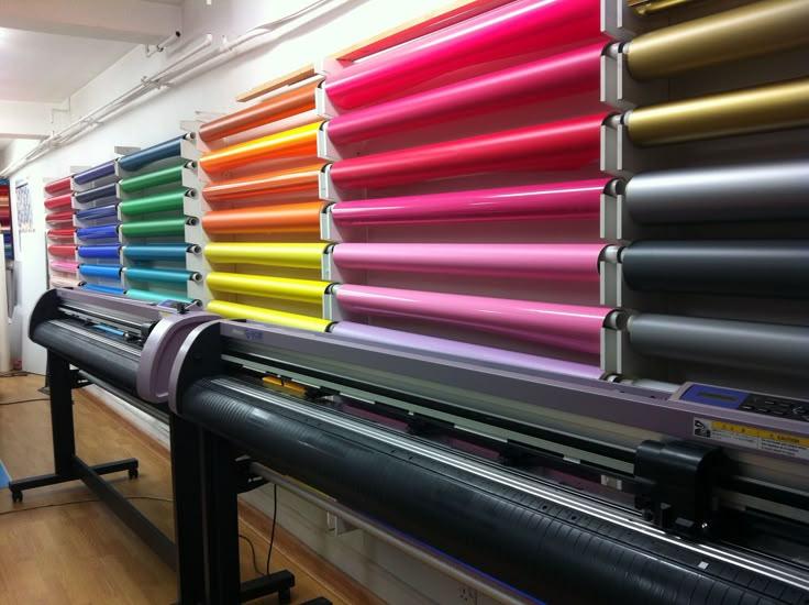 This may contain: a large selection of colored vinyls are on display in a room with wood flooring